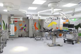 A view of an operating theatre, with bright images on the walls