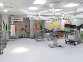 A view of an operating theatre, with bright images on the walls