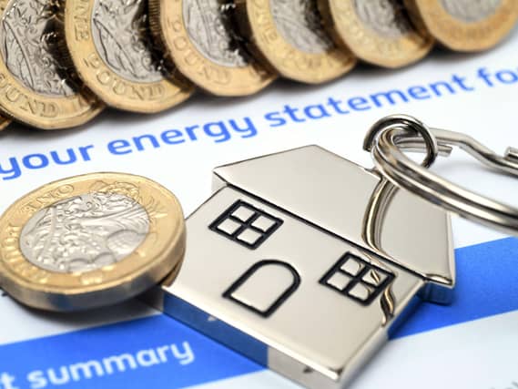 Energy statement with coins and house keyring on top