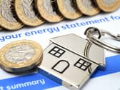 Energy statement with coins and house keyring on top