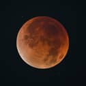 The blood Moon is pictured during an eclipse in the night sky in Shanghai on 8 September 2025.
