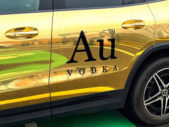 Au Vodka branding on a gold-coloured car