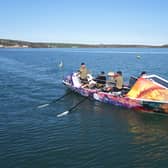 Rowers in a multicoloured boat