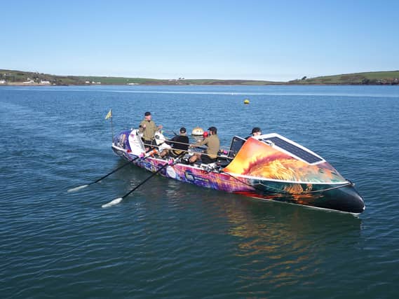 Rowers in a multicoloured boat