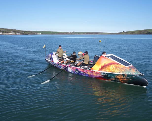 Rowers in a multicoloured boat