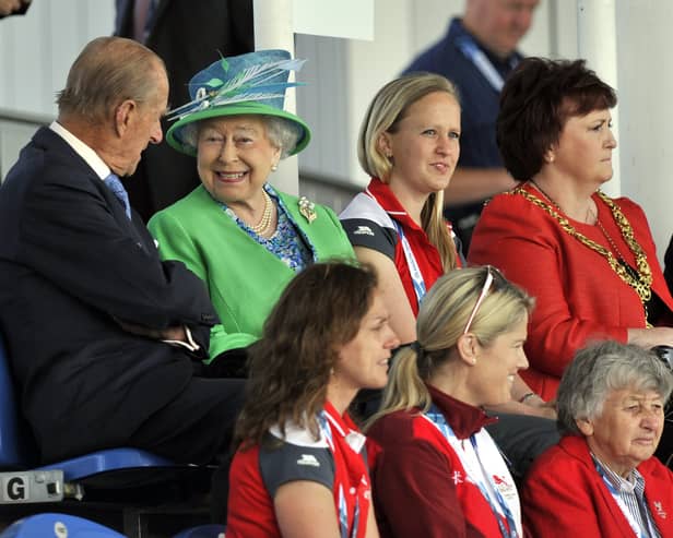 Queen Elizabeth II and the Duke of Edinburgh sit in the stands to watch the England v Wales match at the National Hockey Centre during the 2014 Commonwealth Games in Glasgow. P