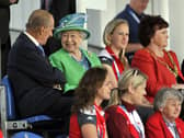 Queen Elizabeth II and the Duke of Edinburgh sit in the stands to watch the England v Wales match at the National Hockey Centre during the 2014 Commonwealth Games in Glasgow. P