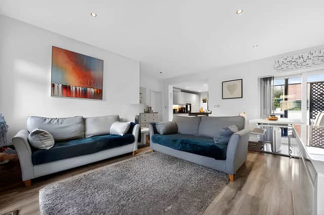 The open-plan dining and living area makes the most of the natural light and creates a welcoming centre to the home