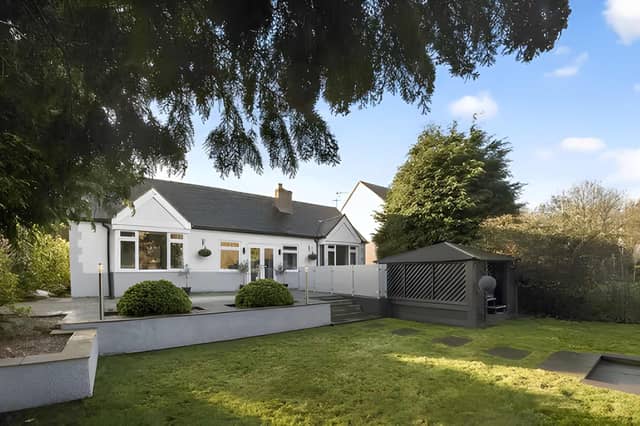 A gated driveway with space for several cars welcomes visitors to this detached bungalow in The Knowle
