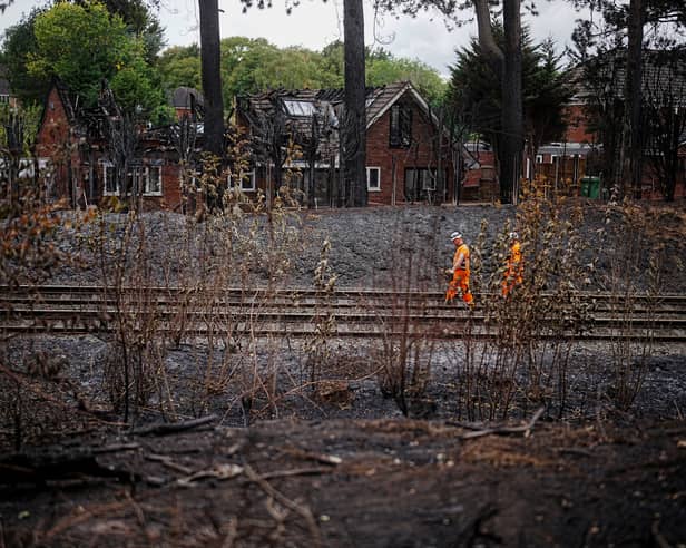 Network rail workers inspect the track and embankment after the Stourbridge wildfire 