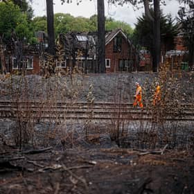 Network rail workers inspect the track and embankment after the Stourbridge wildfire 