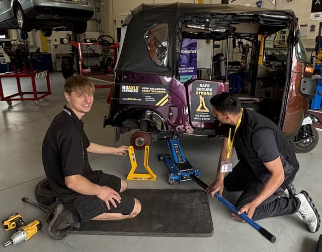 Apprentice Lewis Jones, left, tries his hand at maintenance on the tuk-tuk at Telford College.