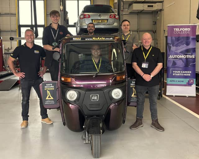Representatives from Telford College, NuAxle and The Professional Recovery Tow Show team with the tuk-tuk at the automotive training centre in Wellington.