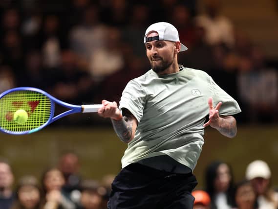 Nick Kyrgios hits a forehand