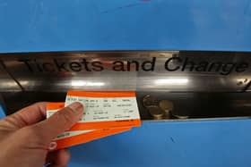 A man collecting train tickets from a machine at Finsbury Park station in north London