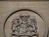 The crest on the exterior of the High Court in Glasgow