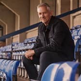Gary Lineker sat in the stands at a sports ground