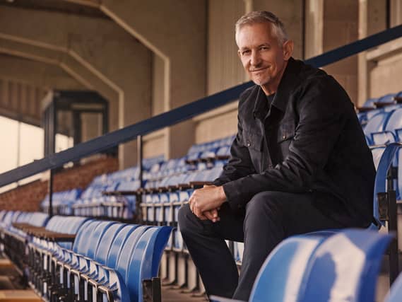 Gary Lineker sat in the stands at a sports ground