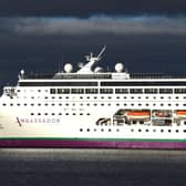 The cruise ship Ambition docked, under grey skies