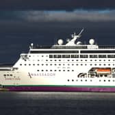 The cruise ship Ambition docked, under grey skies