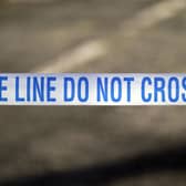 Police tape near a scene of a suspected crime