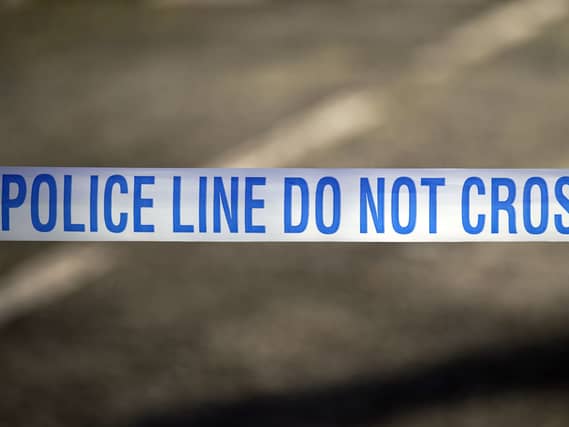Police tape near a scene of a suspected crime
