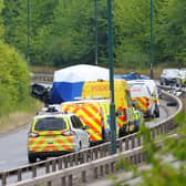Police officers at the scene of a fatal crash involving a police car and a Volkswagen Passat on the A66 in South Bank, near Middlesbrough