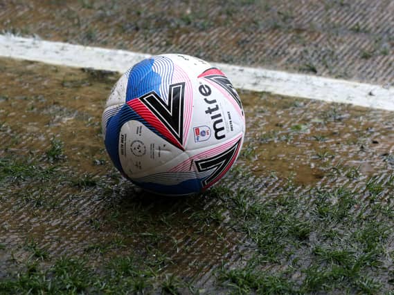 Mitre matchball on the soggy turf before the Sky Bet League Two match at the Jonny-Rocks Stadium, Cheltenham.