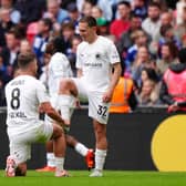 Boreham Wood's Matt Rush, right, celebrates a goal with Zak Brunt pretending to polish his boot