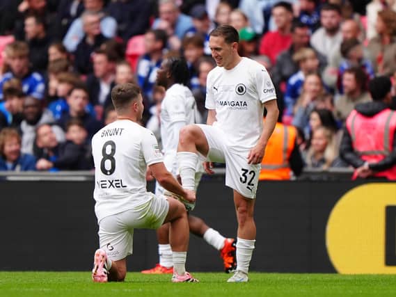 Boreham Wood's Matt Rush, right, celebrates a goal with Zak Brunt pretending to polish his boot