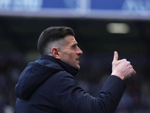 John Mousinho gives a thumbs up gesture