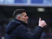 John Mousinho gives a thumbs up gesture
