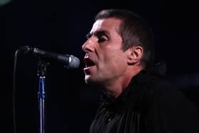 Liam Gallagher singing into a microphone