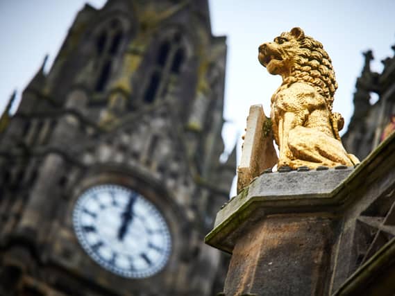 A view of a golden statue and clock tower