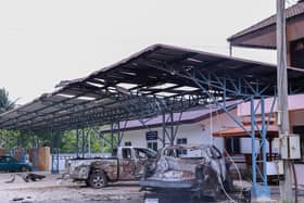 A burned out office and car
