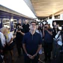 Andy Burnham at a train station in Kyiv, surrounded by photographers