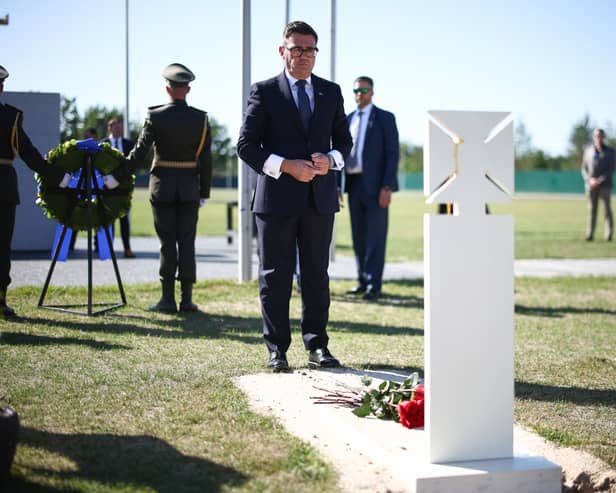 Andy Burnham lays flowers at a grave in Kyiv's national military cemetery
