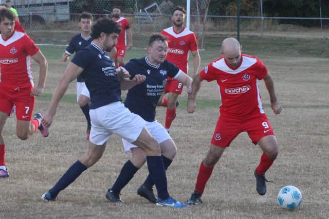 Knighton Town find themselves swarmed during their 1-1 draw with Llanfair United Pictures: Stuart Townsend