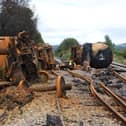 Burned out fuel wagons on a damaged railway line