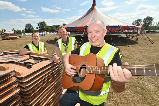 Shrewsbury Folk Festival on its way at the West Midlands Showground, and helping set up is: with guitar: Mike Rowland and Ellie Williams and Simon Rhodes.
