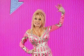 Dolly Parton waves from a stage
