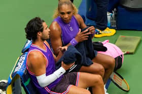 Serena Williams, right, and Carlos Alcaraz talk during a changeover