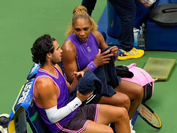Serena Williams, right, and Carlos Alcaraz talk during a changeover
