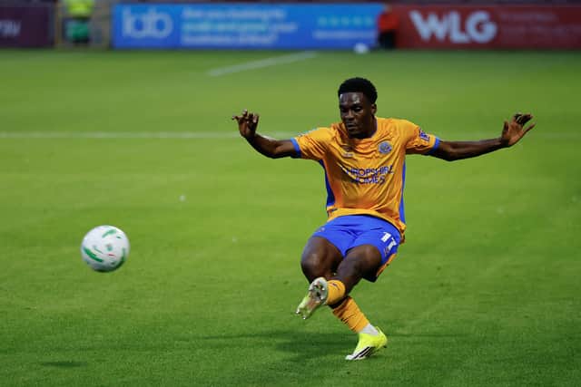 Kevin Berkoe crosses the ball into the box for Shrewsbury Town
