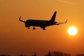A flight takes off in the hazy morning sunshine