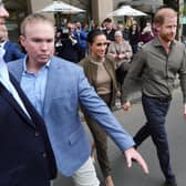 Harry and Meghan with their security