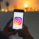 Phone in hands scrolling through Instagram