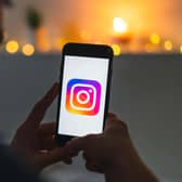 Phone in hands scrolling through Instagram