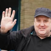 Peter Kay smiling and waving