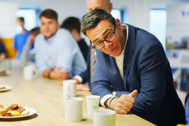 Prime Minister Andy Burnham speaks to members of staff during a visit to Tata Steel in Wales